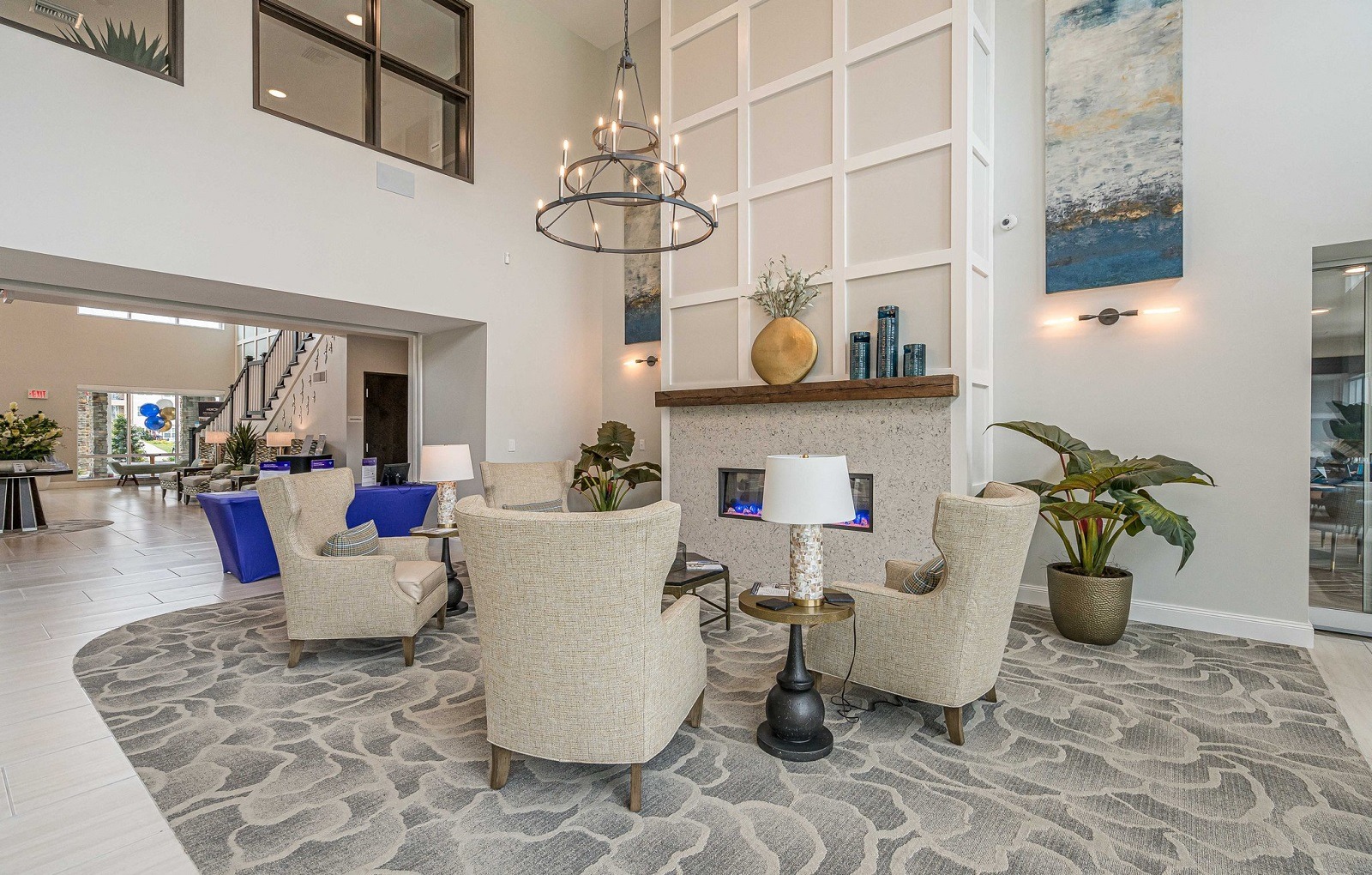 a living room with couches and chairs and a fireplace